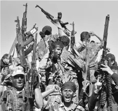  ??  ?? File photo shows newly recruited Houthi fighters ride on the back or a truck during a parade before heading to the front line to fight against government forces, in Sanaa,Yemen. — Reuters photo