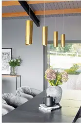  ??  ?? ABOVE ‘THE LIGHTING HANGING OVER THE DINING TABLE, CREATED BY STEVE, IS A TAKE ON THE CLASSIC CYLINDER PENDANT. EACH ONE IS ROLLED FROM A SINGLE SHEET OF BRASS AND DESIGNED WITH A GENTLE SPIRAL, GIVING IT A UNIQUE LOOK.’ Cylinder pendant lights in brass, £125 each, Arcform