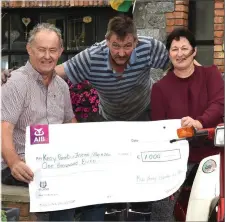  ?? Photo by Michelle Cooper Galvin ?? Tom Kelliher and Ger O’Sullivan presenting €1,000 from the Mid Kerry Honda Run 2017 to Agnes Casey for the KPFA Buy a Bus Campaign. This was at the launch of the Mid Kerry Honda Run 2018, which will be held on July 29.