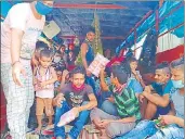  ?? IANS /TWITTER ?? Migrants travelling in a truck being given food items near Karanji on National Highway-7 in Maharashtr­a; and (left) Karnail Singh Khaira, who runs the langar.