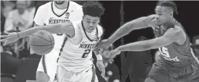  ?? MARK HOFFMAN / MILWAUKEE JOURNAL SENTINEL ?? Minnesota guard Nate Mason strips the ball from Middle Tennessee State guard Aldonis Foote.