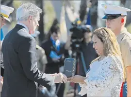  ?? Don Bartletti
Los Angeles Times ?? ROSA PERALTA accepts award from Navy Secretary Ray Mabus. Her son Rafael was credited with saving fellow Marines by shielding them from a grenade.