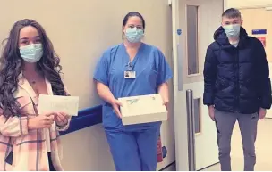  ??  ?? Grand gesture Shane’s daughter Toni Louise and son Charles John, 16, present the cheque to the hospital staff