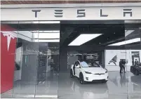  ?? MARK RALSTON TRIBUNE NEWS SERVICE ?? Tesla recently reversed course on store closings, saying it would keep many showrooms and reopen some that it had closed.