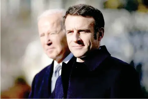  ?? ELIZABETH FRANTZ/REUTERS ?? French President Emmanuel Macron (R) and U.S. President Joe Biden stand together onstage during an official state arrival ceremony for Macron on the South Lawn of the White House in Washington, U.S., on December 1, 2022.