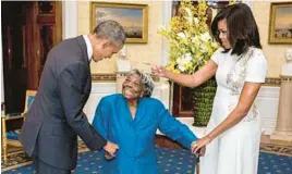  ?? WHITE HOUSE PHOTO BY LAWRENCE JACKSON ?? President Barack Obama and lirst lady Michelle Obama greet then-106-year-old Virginia McLaurin in the Blue Room of the White House before a reception celebratin­g African American History Month in February 2016.