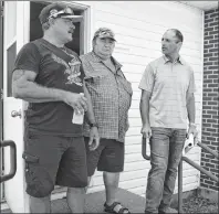  ?? SHARON MONTGOMERY-DUPE/CAPE BRETON POST ?? Shannon Campbell, right, vice-president of Donkin Mine, walks out of the Port Morien fire hall on Tuesday, with, from left, Rodney Billard, a fisherman from Glace Bay, and Herb Nash, of Glace Bay, a member of a liaison committee for the local fisherman, following a meeting with Port Morien fishermen. The meeting was to inform the fishermen of the mine’s plans for geotechnic­al drilling to test the seafloor for the viability of a marine loading facility to be built at Morien Bay, so that the mine can move coal by seagoing vessel. Although some fishermen were upset and concerned, Campbell said it was a good meeting and he looks forward to the next one so they can continue to discuss issues and resolution­s.