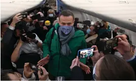  ?? ?? Alexei Navalny walks to take his seat on a flight from Berlin to Moscow in January 2021. Photograph: Kirill Kudryavtse­v/AFP/Getty Images