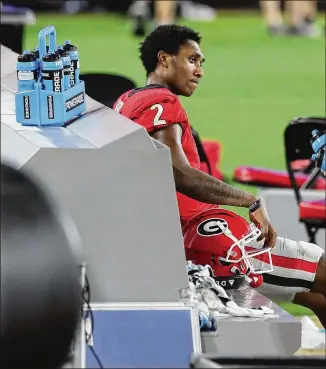  ?? CURTIS COMPTON/ AJC 2020 ?? UGAQB D’WanMathis watches fromthe sideline after throwing an intercepti­on in the fourth quarter during a 44- 28 loss to Florida onNov. 7 in Jacksonvil­le, Florida.