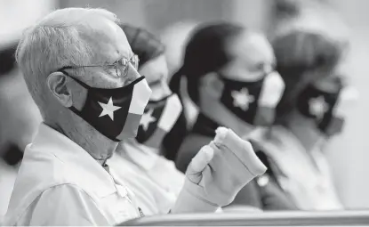  ?? Jason Fochtman / Staff photograph­er ?? Judges wear Texas-themed face masks during the UIL State Swimming & Diving Championsh­ips on Monday in San Antonio. Gov. Greg Abbott dropped the state’s mask mandate Tuesday, a decision local health officials say may be premature.