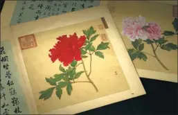  ??  ?? A Qing Dynasty (1644-1911) painting album of Chinese roses fetches 173.6 millon yuan ($22 million) at a Beijing auction.