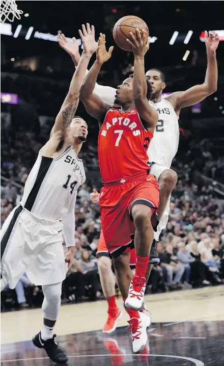  ?? — AP ?? Toronto Raptors guard Kyle Lowry drives to the basket past San Antonio Spurs guard Danny Green, left, and forward LaMarcus Aldridge during an NBA basketball game Monday in San Antonio.