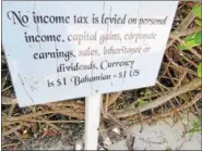  ?? JANET PODOLAK — THE NEWS-HERALD ?? Informatio­nal signs about the Bahamas are tucked along paths though the sea grapes on Half Moon Cay, an island owned by Holland America.