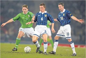  ??  ?? (Top) David Weir, Tom Boyd, Christian Dailly and Paul Lambert wave farewell to France 98, but (below) the latter was back to mentor a young Barry Ferguson with Scotland