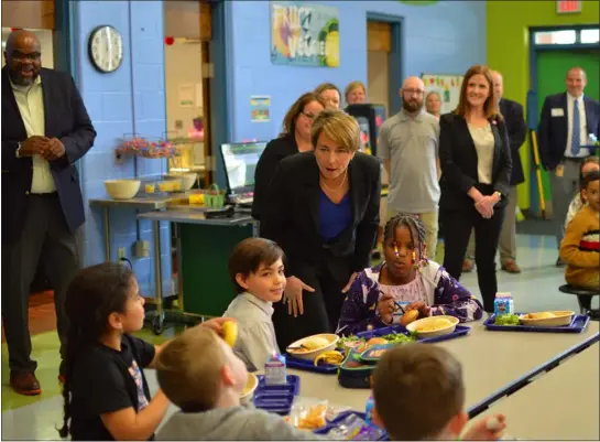  ?? PETER CURRIER — LOWELL SUN ?? Gov. Maura Healey greets second-graders at Billerica’s Hajjar Elementary School during their lunchtime on Thursday. At back left is state Secretary of Education Patrick Tutwiler.