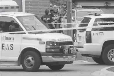  ?? CHRIS YOUNG, THE CANADIAN PRESS ?? Police swarmed a neighbourh­ood in east Toronto Thursday where three people were fatally injured with a crossbow.