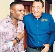  ?? IAN ALLEN/PHOTOGRAPH­ER ?? Dr Christophe­r Tufton (right), minister of health, and Omar McLeod, Olympic and World Championsh­ips 110-metre hurdles champion, share some laughs.