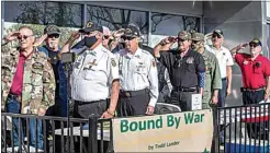  ??  ?? Local veterans salute during the singing of the National Anthem on Monday.