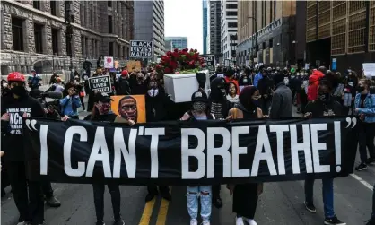  ?? Photograph: Chandan Khanna/AFP/Getty Images ?? Silent March for Justice in front of the Hennepin County Government Center on 7 March 2021, where the trial of former police officer Derek Chauvin is underway.