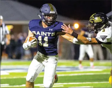  ?? Special to NWA Democrat-Gazette/DAVID BEACH ?? Shiloh Christian’s Jaret Russ (left) runs the ball for a touchdown as Kaine Caswell of Prairie Grove misses the tackle Friday at Champions Stadium in Springdale.