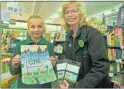  ?? PHOTO: CLINTON LLEWELLYN. ?? Paige McEwan with her winning Ross Shield art competitio­n entry, receiving her vouchers from Raewyn Reihana from Paper Plus.