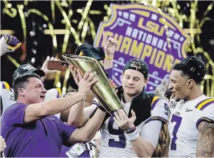  ?? SUE OGROCKI THE ASSOCIATED PRESS ?? LSU head coach Ed Orgeron, left, and quarterbac­k Joe Burrow, centre, hold the trophy beside safety Grant Delpit after the NCAA national championsh­ip game against Clemson on Monday.