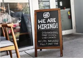  ?? JOE RAEDLE Getty Images ?? Many businesses, such as this Miami restaurant, are looking to add staff, but there were still 3.6 million fewer jobs in the U.S. economy in October compared to the end of 2019.