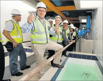  ?? Pictures: WERNER HILLS ?? THUMBS UP: Having a drink of water at the commission­ing of Phase Two of the Nooitgedag­t low-level scheme close to Sunlands yesterday are mayor Athol Trollip, front, with infrastruc­ture, engineerin­g and electricit­y portfolio head Annette Lovemore and mayoral committee member Rano Kayser