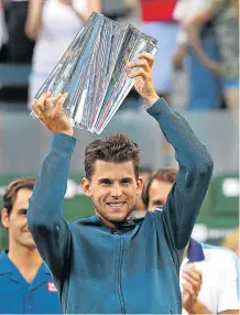  ?? Picture: JAYNE KAMIN-ONCEA-USA TODAY SPORTS ?? GET A HOLD OF THIS: Austrian Dominic Thiem holds the trophy after defeating Roger Federer in the Paribas Open final at Indian Wells.