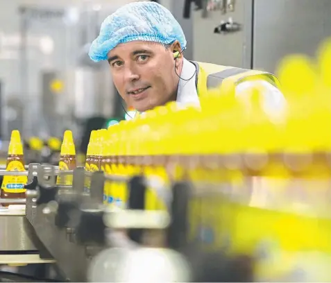  ??  ?? SPREADING THE NEWS: Capilano CEO Ben McKee on the honey filling line, at their production plant in Richlands, Brisbane.