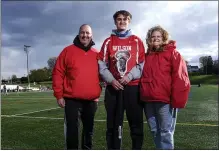  ?? BEN HASTY — READING EAGLE ?? Wilson senior Corey Powers with his parents Sean, left, and Tracy.