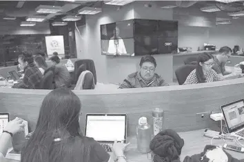  ?? AGENCE FRANCE PRESSE ?? This file photo taken on Jan. 15, 2018 shows employees of online portal Rappler working at the company's editorial office in Manila. Philippine President Rodrigo Duterte's move to ban critical news website Rappler from covering the presidenti­al palace is a threat to press freedom, rights and media groups said on Feb. 21, 2018.