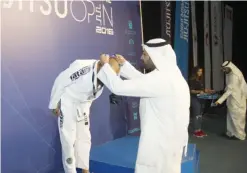  ??  ?? Khaled Al Otaibi, Manager, Gulf Bank presenting a medal to one of the winners.