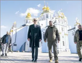  ?? AP photo ?? U.S. President Joe Biden walks with Ukrainian President Volodymyr Zelenskyy at St. Michael’s Golden-Domed Cathedral on a surprise visit on Monday, in Kyiv.