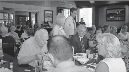  ?? Diane Wagner / Rome News-Tribune ?? Rep. Tom Graves (standing) greets attendees Tuesday at the Floyd County Republican Women’s monthly lunch meeting at Red Lobster.