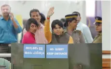  ?? — Reuters ?? Activist Trupti Desai waves from inside the airport in Kochi on Friday.