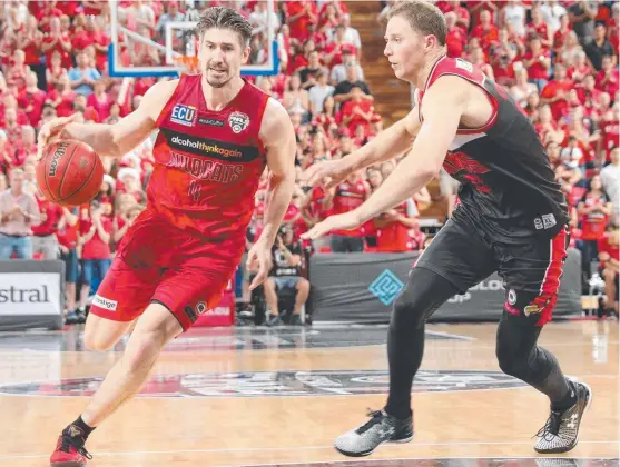  ?? TOUGH GAME: Perth Wildcats veteran Greg Hire is guarded by Illawarra Hawks forward Tim Coenraad during game one of the NBL grand final series. ??