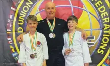  ?? Photograph: Rab Neil ?? From left to right: Seoras Neil, Rab Neil and Fraser Pollock with their medals in Ireland.