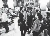  ??  ?? People gather inside a would-be polling station in Barcelona, on October 1, to prevent the police from sealing it off in a referendum on independen­ce for Catalonia banned by Madrid.