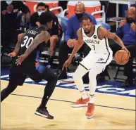  ?? Brad Penner / Associated Press ?? The Nets’ Kevin Durant (7) dribbles while defended by the Knicks’ Julius Randle (30) on Wednesday.