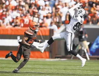  ?? Joe Robbins / Getty Images ?? Raiders receiver Amari Cooper goes up for a catch in front of Cleveland’s Joe Haden in the first quarter. Cooper had 100 receiving yards before halftime in just his third NFL game.