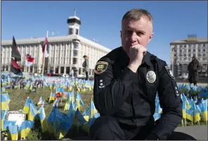  ?? (AP/Bela Szandelszk­y) ?? Ukrainian police officer Volodymyr Nikulin poses for a photo Monday in downtown Kyiv. Nikulin helped Associated Press journalist­s during the siege of Mariupol, in the early days of Russia’s invasion of Ukraine in 2022, while filming “20 Days in Mariupol” which won the best documentar­y Oscar on Sunday night.