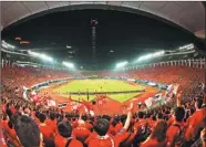  ??  ?? Residents watch a soccer game held at Tianhe Stadium in Tianhe district of Guangzhou.