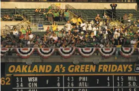  ?? Santiago Mejia / The Chronicle ?? Oakland A’s fans who sit above the right-field scoreboard are among the most devoted at the Coliseum, an aging facility that is one of the oldest in baseball.