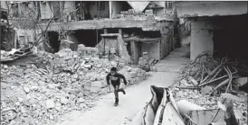  ?? ABD DOUMANY/GETTY-AFP ?? A Syrian boy makes a run for it Sunday in the rebel-held town of Douma, near Damascus.