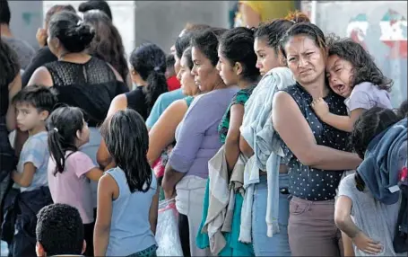  ?? Genaro Molina Los Angeles Times ?? ASYLUM SEEKERS wait in Nuevo Laredo, Mexico. Only migrants with future U.S. court dates scheduled can be sent back into Mexico.