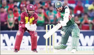 ??  ?? Bangladesh’s Tamim Iqbal (right), bats during a Twenty20 internatio­nal cricket match against the West Indies on
Aug 5, in Lauderhill, Fla. At left is West Indies wicketkeep­er Denesh Ramdin. (AP)
