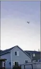  ?? COURTNEY JUNKA VIA AP ?? This photo shows the stolen Horizon Air turboprop plane flying over Eatonville, Wash., on Friday.