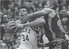  ?? JONATHAN DANIEL/GETTY IMAGES ?? Giannis Antetokoun­mpo scored the winning bucket as the Milwaukee Bucks beat Al Horford and the Boston Celtics in Game 4 Sunday in Milwaukee to even their first-round series 2-2.