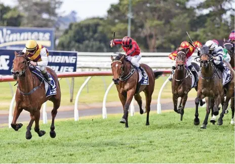  ?? Photo: Nev Madsen ?? BOUNDING AWAY: Jim Byrne lets loose on Get Stuck In to record a dominant four and three quarter length victory in the Toowoomba Plastics Maiden Handicap (1200m) at Clifford Park yesterday.